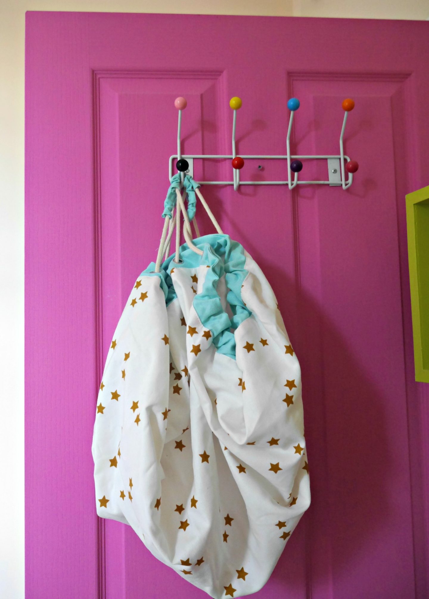Colourful pink door and Vertbaudet toy bag