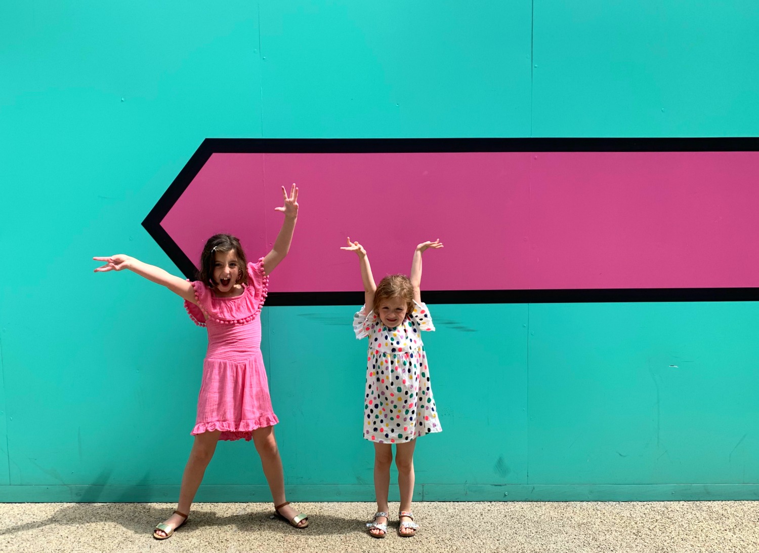 Colourful pink and green arrow wall at London Kings Cross